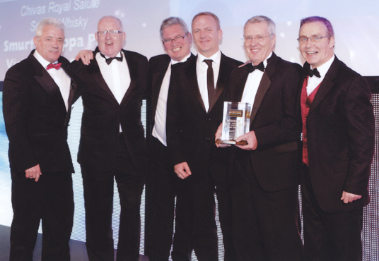 Kevin Keegan OBE congratulates the Smurfit Kappa Tannochside team on the success of their high-quality packaging for Chivas Brothers, Royal Gold Salute 21 year old whisky. Shown L to R are Kevin Keegan OBE, Peter Martin (SK), John Glancy (SK), Robert Richie (Chivas Bros.), John Gall (Sponsor) and Jamie Howe (SK)